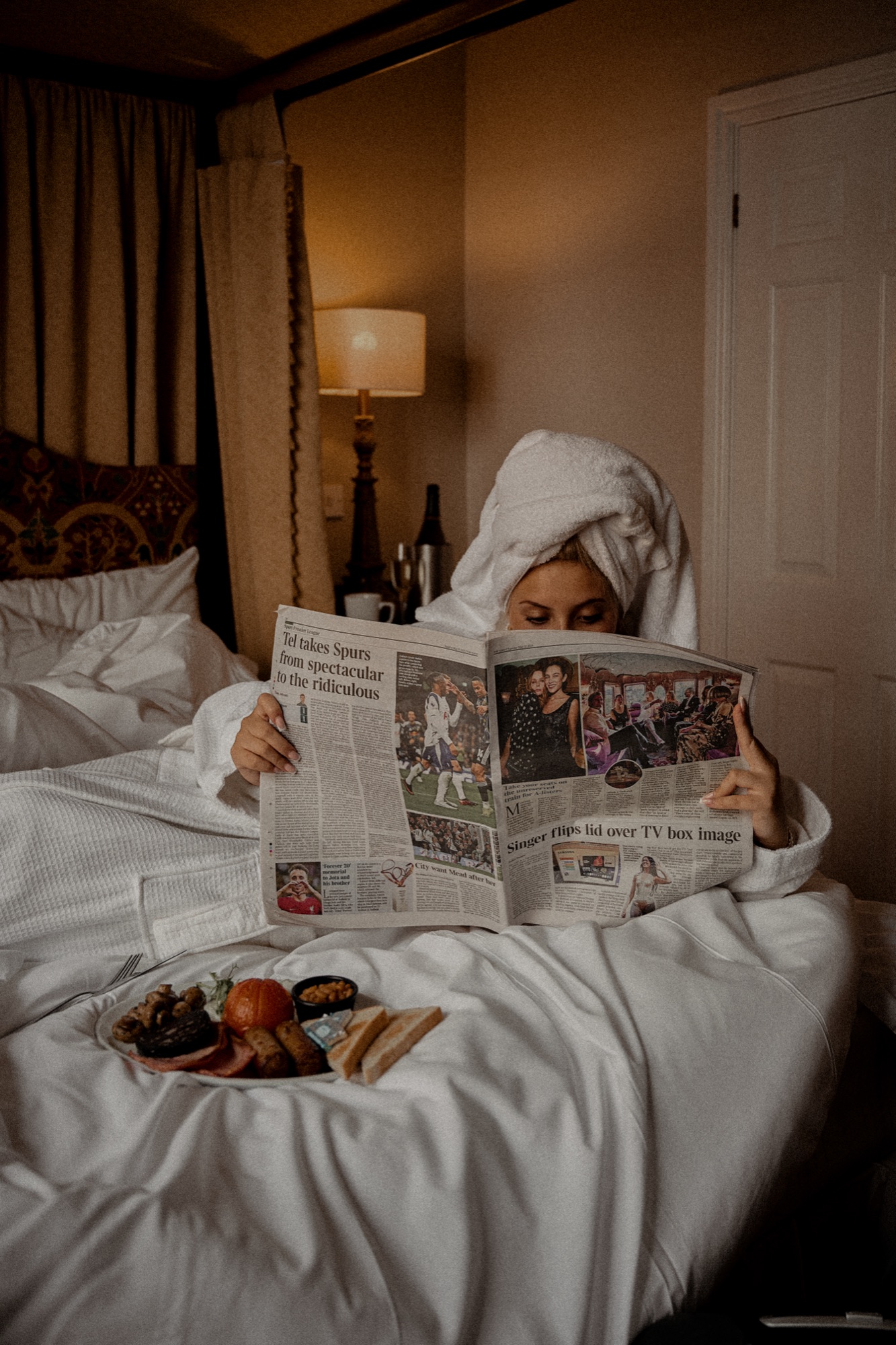 A breakfast setting with folded newspapers on a table at The Red Lion, soft daylight.