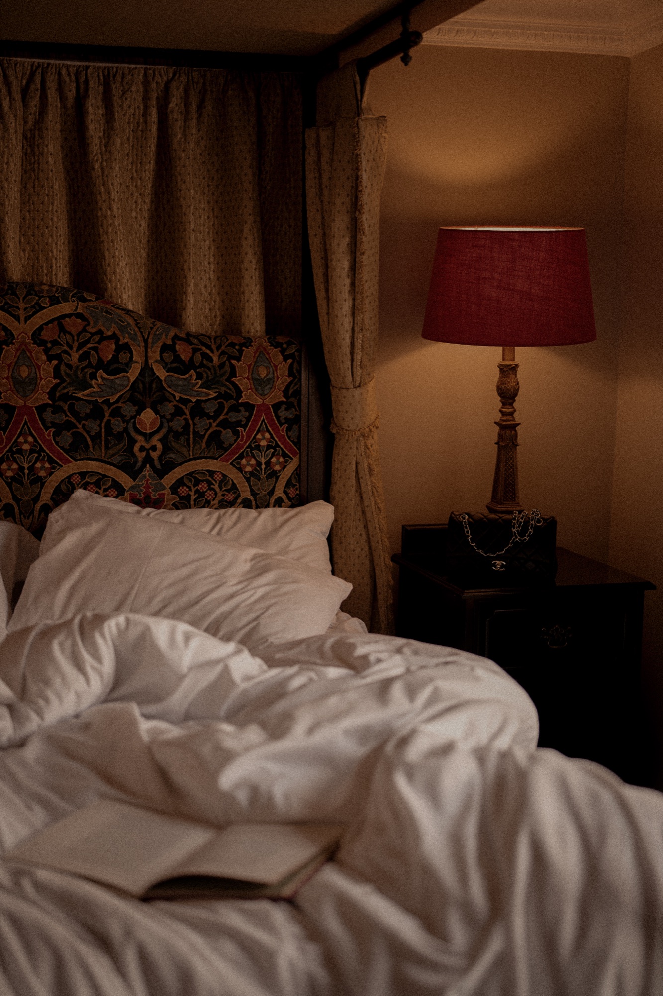 A bedside lamp and shade detail in a guest room at The Red Lion, warm evening tone.