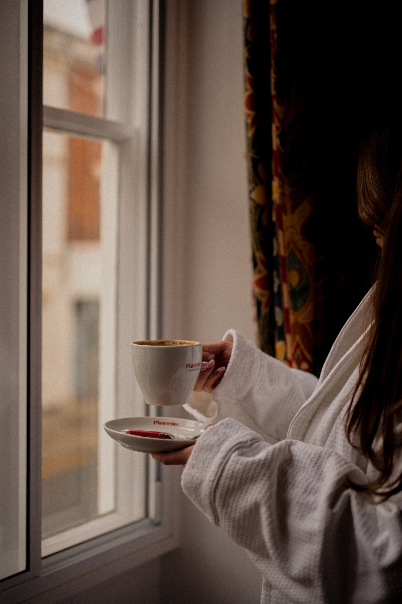 A coffee cup on a windowsill table at The Red Lion with soft natural daylight.