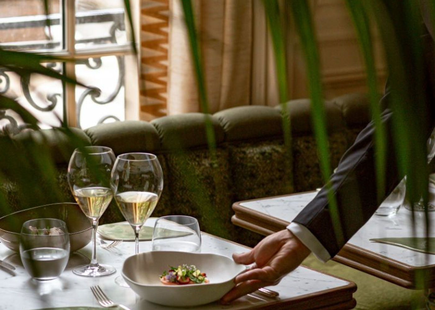 Elegant fine dining table in boutique hotel restaurant with plated dish, champagne glasses and marble table, hospitality guest experience marketing concept