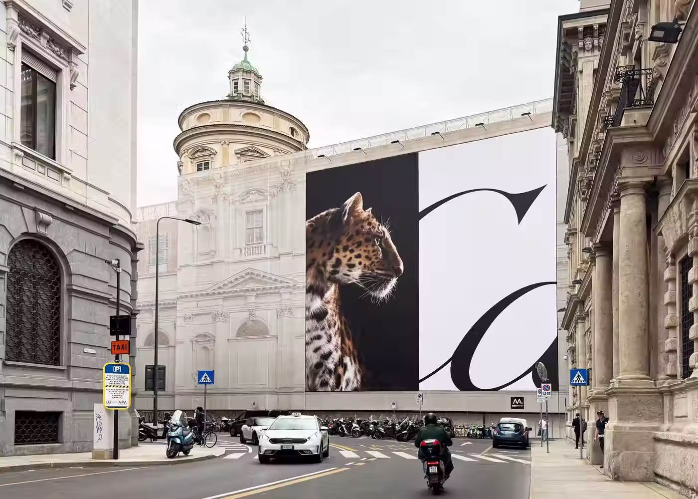 Large-scale Cartier panther billboard displayed between classical buildings, illustrating the power of consistent luxury brand symbolism.