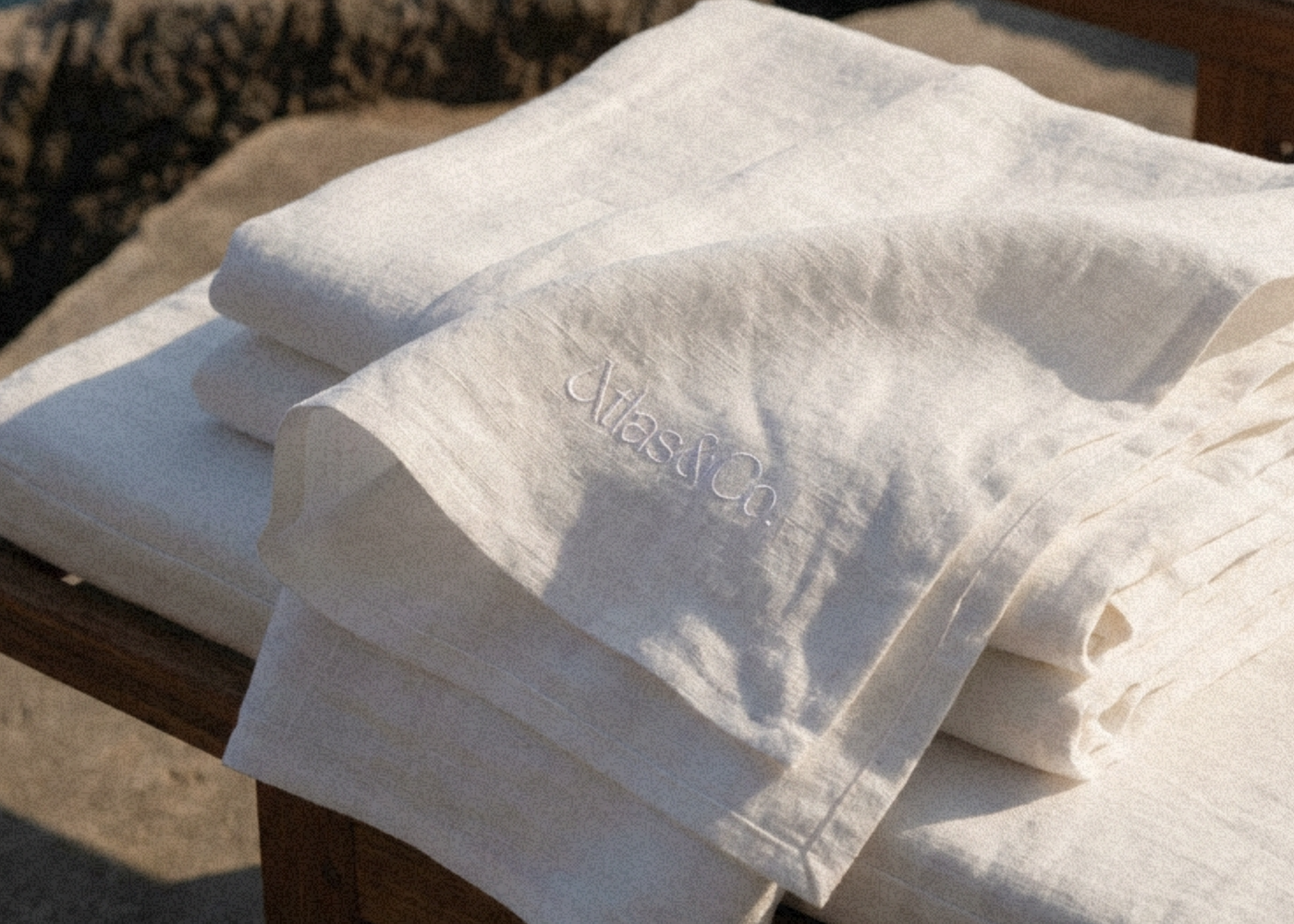 Embossed linen featuring the Atlas & Co brand mark.