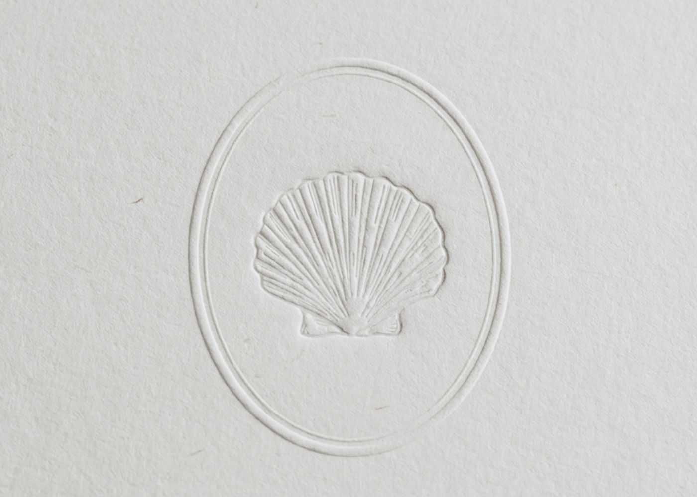 Blind-embossed shell brand marque for Atlas & Co.